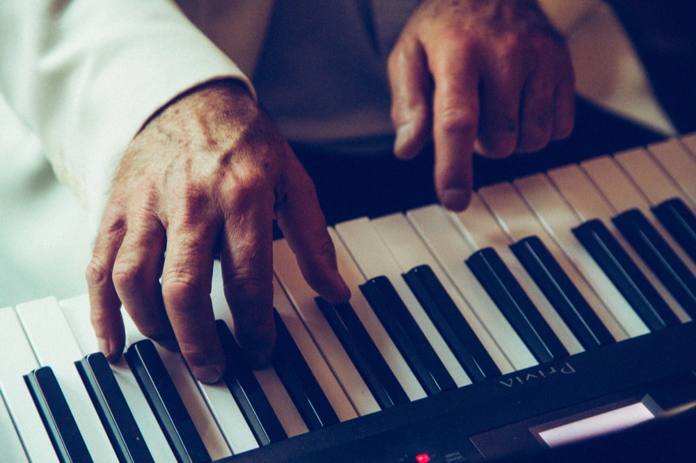 Close-up of hands playing a piano keyboard