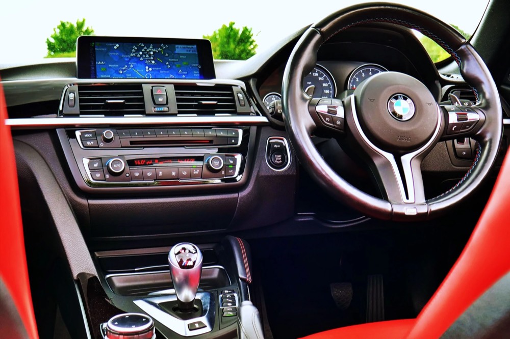 The interior of a BMW M car: steering wheel, gear lever and dashboard