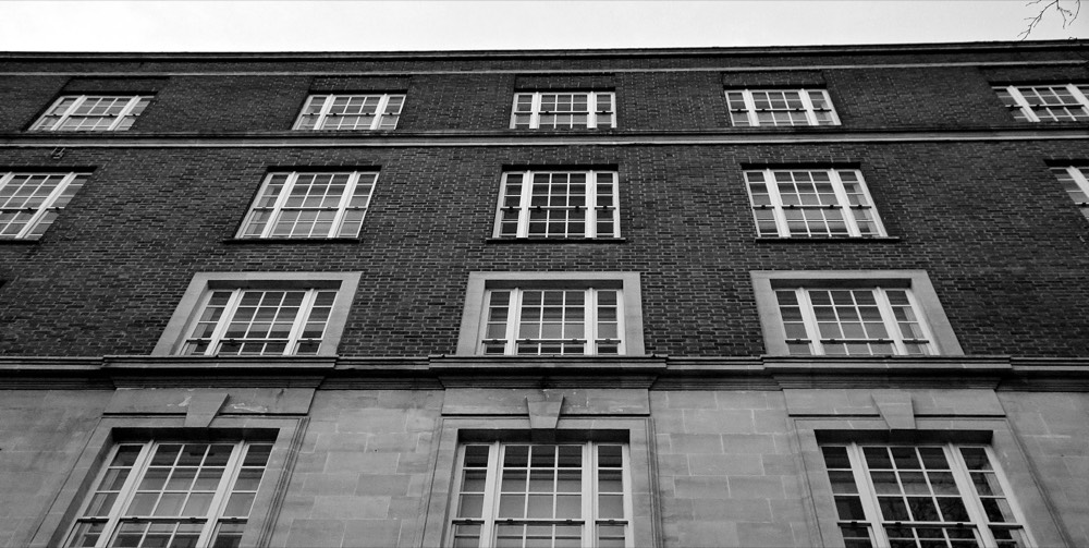 A brick building facade in black and white