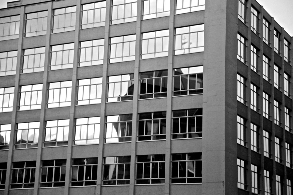A grid of office windows in black and white
